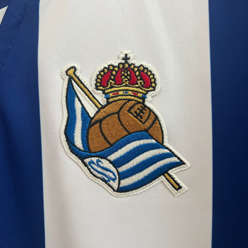 Camisa Real Sociedad Home 24/25 - Macron Torcedor Masculina Lançamento